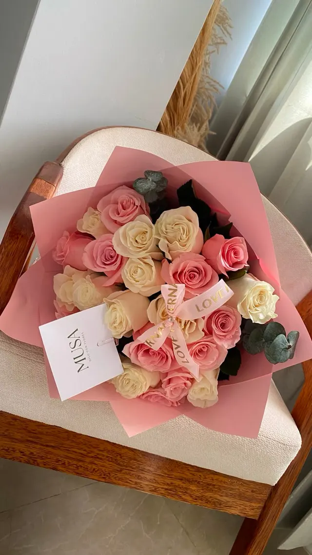 Ramo de rosas rosadas y blancas con papel rosado